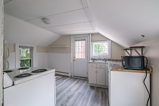 83 Brackett St, Portland, ME 04102 - kitchen with light wood-type flooring, a baseboard radiator, white range with electric cooktop, vaulted ceiling, and black microwave