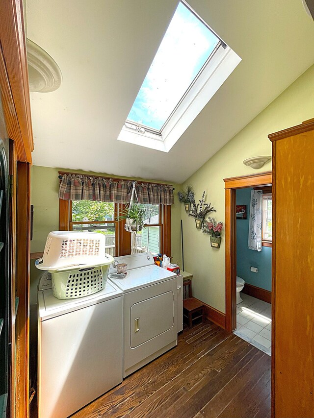 121 Bolton St, Portland, ME 04102 - laundry room featuring a skylight, washing machine and dryer, dark wood-type flooring, and baseboards
