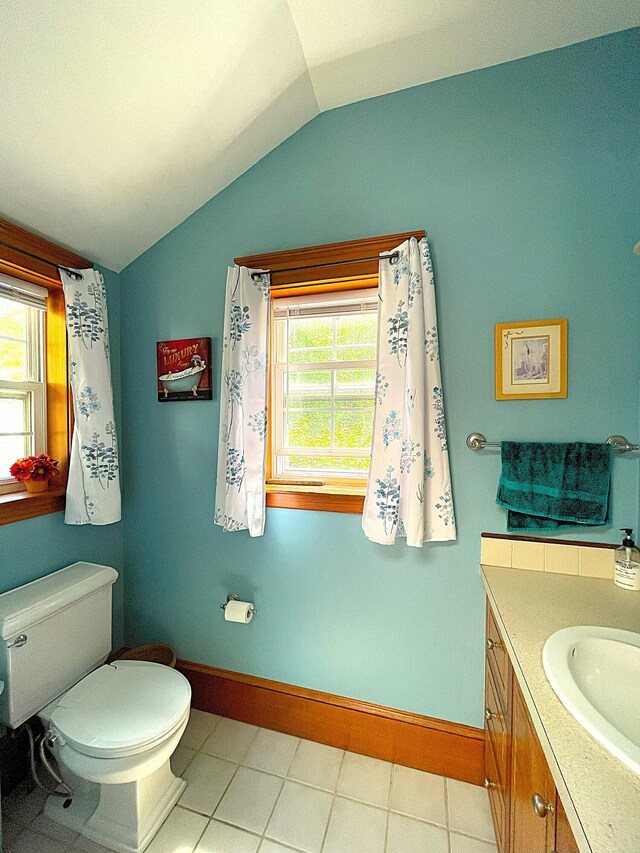 121 Bolton St, Portland, ME 04102 - bathroom with vaulted ceiling, healthy amount of natural light, toilet, vanity, and baseboards