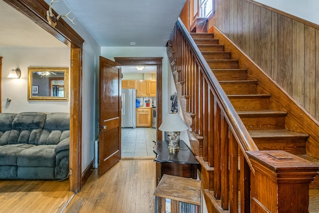 121 Bolton St, Portland, ME 04102 - staircase featuring wooden walls and hardwood / wood-style floors