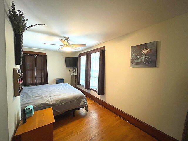 121 Bolton St, Portland, ME 04102 - bedroom featuring baseboards, wood finished floors, and a ceiling fan
