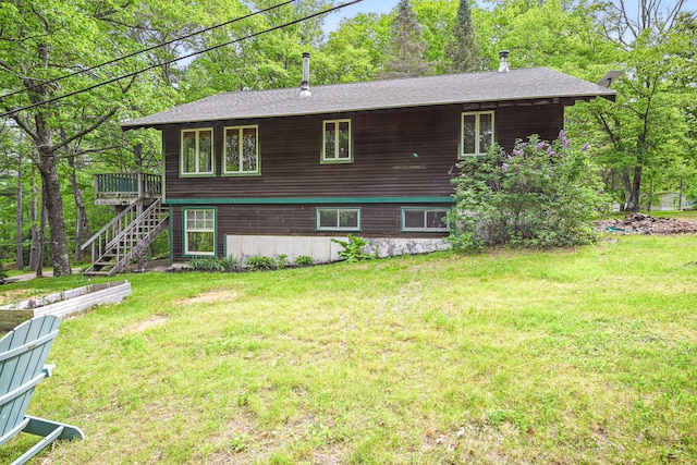 14 Greenleaf Ln, Monmouth, ME 04259 - back of property featuring stairs, a lawn, a wooden deck, and a shingled roof