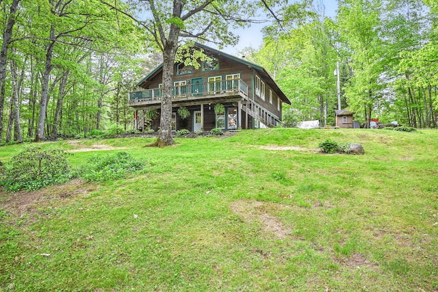 14 Greenleaf Ln, Monmouth, ME 04259 - rear view of house with stairway, a wooden deck, and a yard