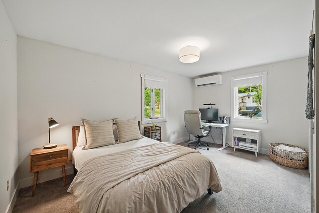 14 Greenleaf Ln, Monmouth, ME 04259 - carpeted bedroom featuring a wall mounted AC, multiple windows, and baseboards