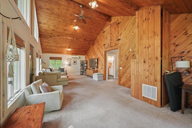 14 Greenleaf Ln, Monmouth, ME 04259 - living room with carpet floors, wood walls, a wall mounted air conditioner, a ceiling fan, and high vaulted ceiling