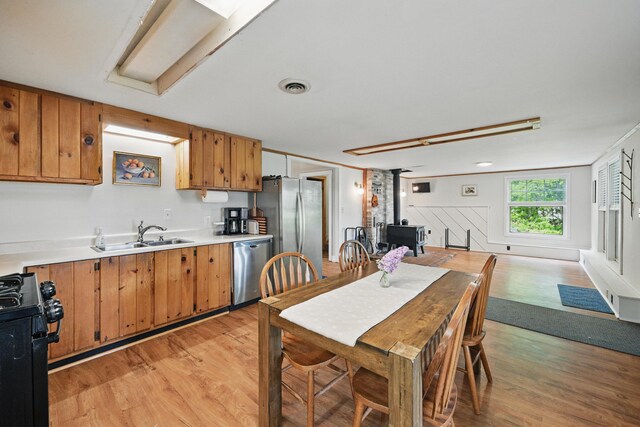 14 Greenleaf Ln, Monmouth, ME 04259 - dining space featuring light wood finished floors and a wood stove