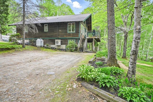 14 Greenleaf Ln, Monmouth, ME 04259 - view of front of house featuring stairway, a wooden deck, a shingled roof, and ac unit