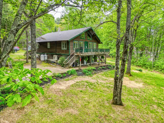 14 Greenleaf Ln, Monmouth, ME 04259 - rear view of property with a deck, stairs, a shingled roof, and a view of trees
