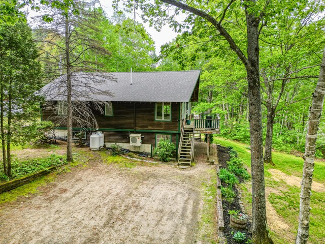 14 Greenleaf Ln, Monmouth, ME 04259 - view of front facade featuring stairway, a shingled roof, and a wooden deck
