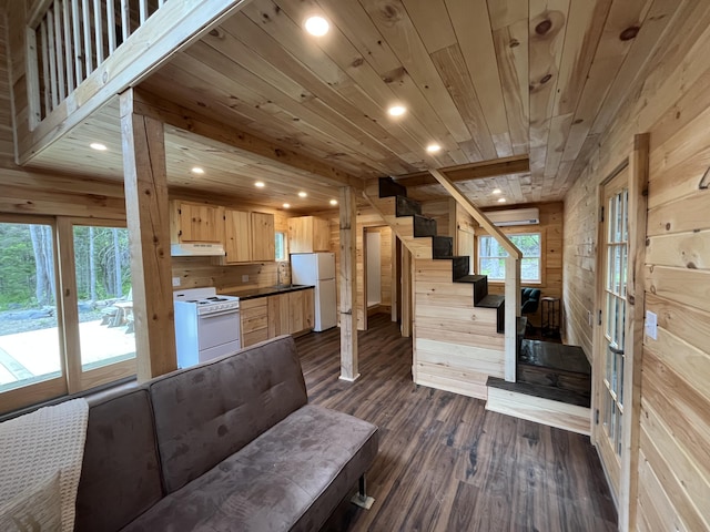 105 Gales Rd, Abbot, ME 04406 - unfurnished living room with wood walls, plenty of natural light, recessed lighting, wood ceiling, and stairway