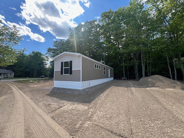 440 High St, Sanford, ME 04073 - view of home's exterior featuring dirt driveway and view of wooded area