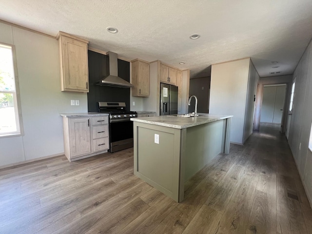 440 High St, Sanford, ME 04073 - kitchen featuring stainless steel gas range oven, wall chimney exhaust hood, a sink, light wood-style floors, and a textured ceiling
