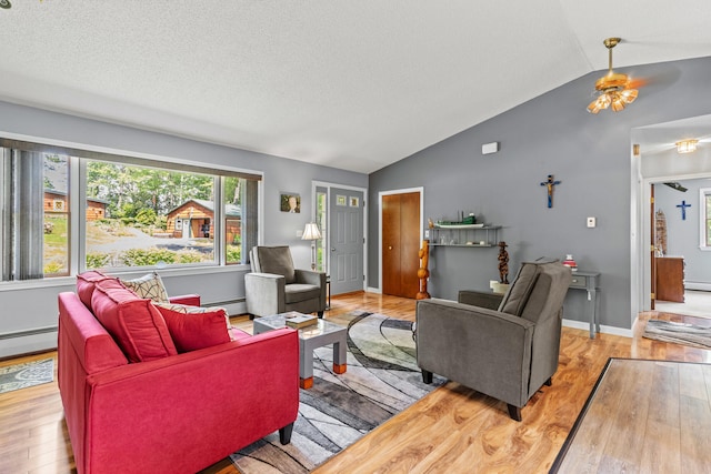 23 E Eleanor Ave, Standish, ME 04084 - living area featuring lofted ceiling, wood finished floors, a baseboard heating unit, ceiling fan, and a textured ceiling