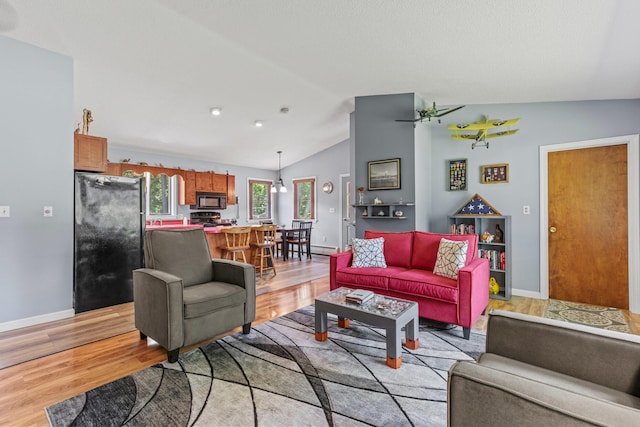 23 E Eleanor Ave, Standish, ME 04084 - living room featuring lofted ceiling and light wood-style floors