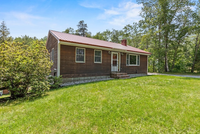 23 E Eleanor Ave, Standish, ME 04084 - view of front facade featuring a front yard, a chimney, and a metal roof