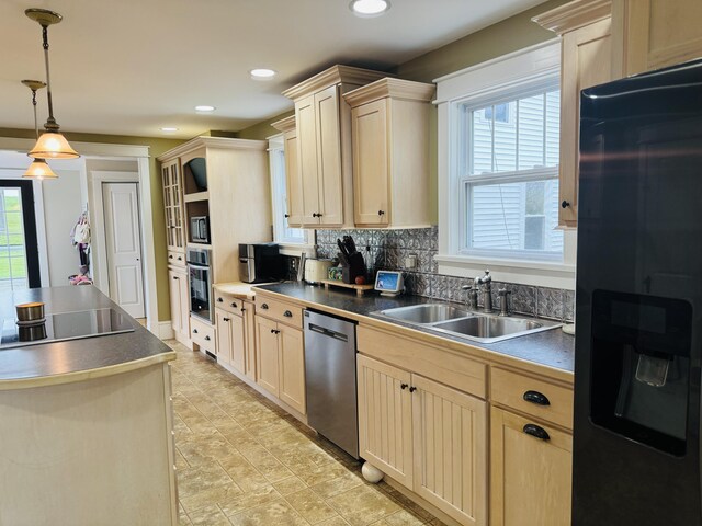 228 Mcburnie Rd, Presque Isle, ME 04769 - kitchen featuring appliances with stainless steel finishes, dark countertops, decorative backsplash, light brown cabinets, and hanging light fixtures