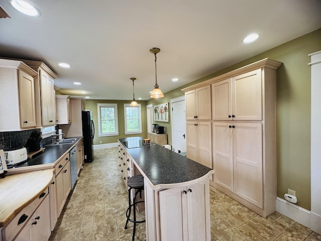 228 Mcburnie Rd, Presque Isle, ME 04769 - kitchen featuring black appliances, a center island, dark countertops, recessed lighting, and a kitchen bar