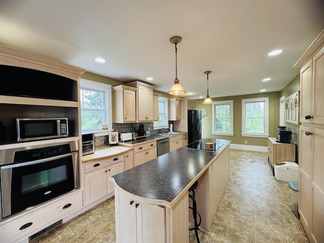 228 Mcburnie Rd, Presque Isle, ME 04769 - kitchen featuring black appliances, a center island, backsplash, recessed lighting, and dark countertops