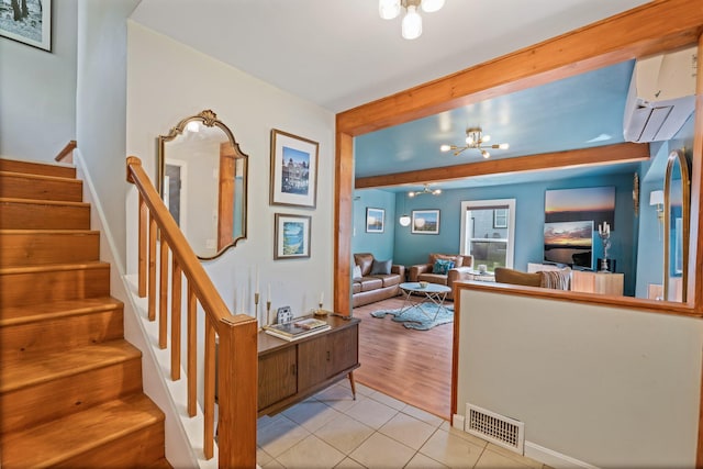 194 Larkin St, Bangor, ME 04401 - tiled living room with a wall mounted AC, stairway, a chandelier, and beam ceiling