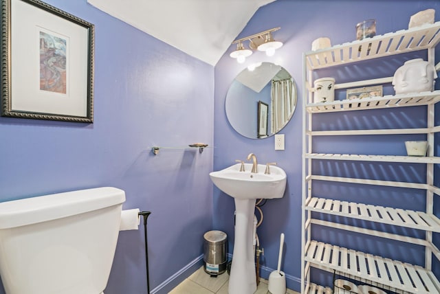 194 Larkin St, Bangor, ME 04401 - bathroom featuring toilet, vaulted ceiling, baseboards, tile patterned flooring, and a sink
