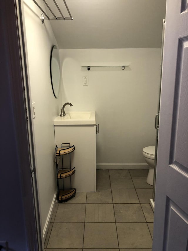 194 Larkin St, Bangor, ME 04401 - bathroom featuring toilet, vanity, tile patterned flooring, and baseboards