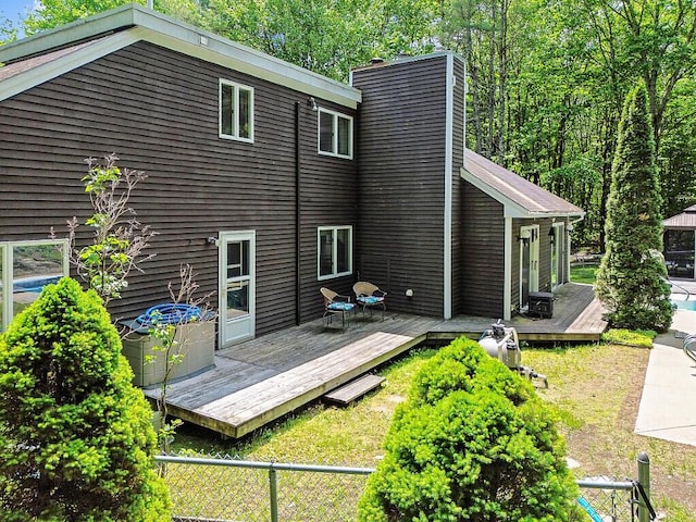 363 Winthrop Center Rd, Winthrop, ME 04364 - rear view of property featuring a wooden deck, a chimney, and cooling unit