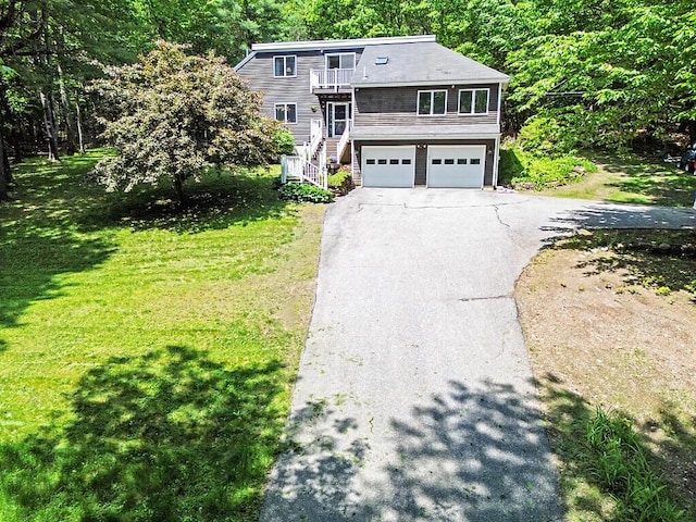 363 Winthrop Center Rd, Winthrop, ME 04364 - view of front facade with stairway, asphalt driveway, an attached garage, a front lawn, and a balcony