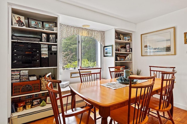 363 Winthrop Center Rd, Winthrop, ME 04364 - dining space featuring wood finished floors, a baseboard heating unit, and baseboards