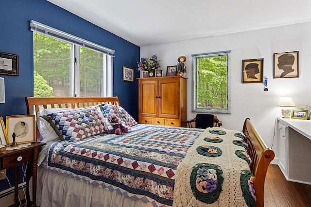 363 Winthrop Center Rd, Winthrop, ME 04364 - bedroom with multiple windows, wood finished floors, and baseboard heating