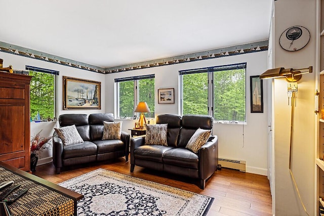 363 Winthrop Center Rd, Winthrop, ME 04364 - living room featuring a baseboard heating unit, plenty of natural light, and light wood-style floors