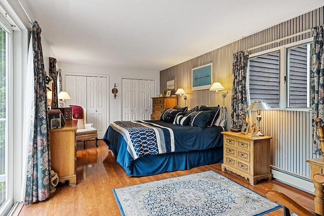 363 Winthrop Center Rd, Winthrop, ME 04364 - bedroom featuring multiple closets, wood finished floors, and baseboard heating