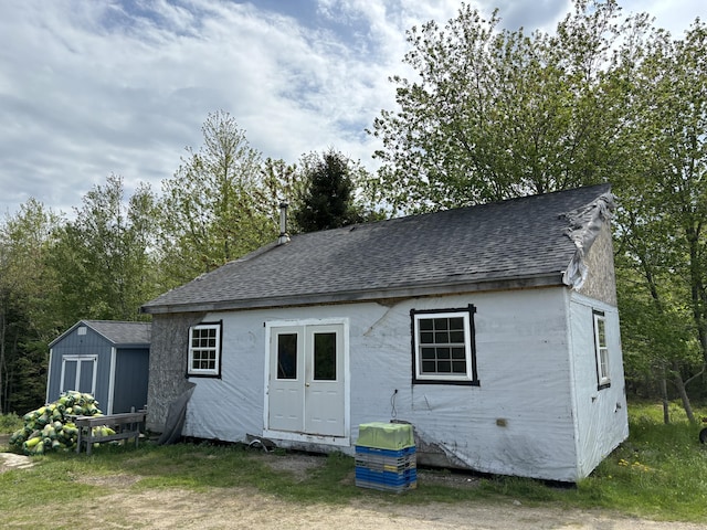 25 Raccoon Rd, Cushing, ME 04563 - back of house with roof with shingles and a shed