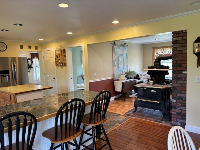 25 Raccoon Rd, Cushing, ME 04563 - dining space with dark wood-style flooring, crown molding, a wood stove, and recessed lighting