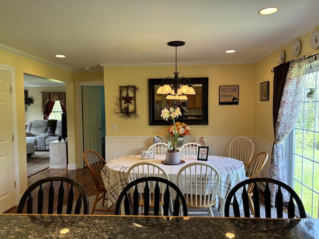 25 Raccoon Rd, Cushing, ME 04563 - dining area featuring plenty of natural light, wood finished floors, a chandelier, a wainscoted wall, and ornamental molding