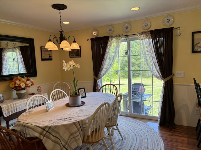 25 Raccoon Rd, Cushing, ME 04563 - dining area featuring a chandelier, wood finished floors, wainscoting, and crown molding