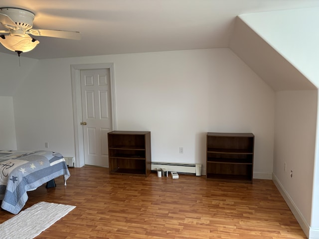 25 Raccoon Rd, Cushing, ME 04563 - bedroom featuring a baseboard radiator, light wood finished floors, vaulted ceiling, ceiling fan, and baseboard heating
