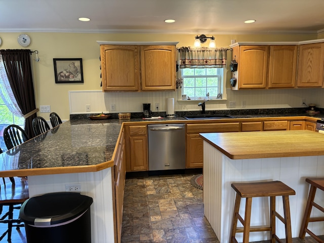25 Raccoon Rd, Cushing, ME 04563 - kitchen featuring stainless steel dishwasher, a peninsula, a breakfast bar area, tile counters, and crown molding