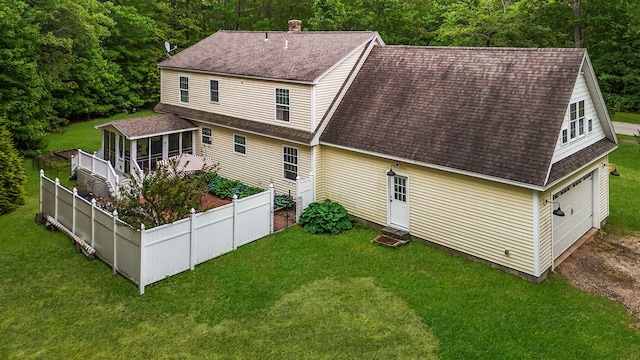176 Weeks Rd, Gorham, ME 04038 - rear view of house featuring a shingled roof, a sunroom, a chimney, entry steps, and a garden
