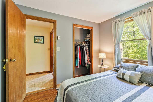 125 Lone Indian Trl, Augusta, ME 04330 - bedroom with wood finished floors, baseboards, a closet, and a walk in closet