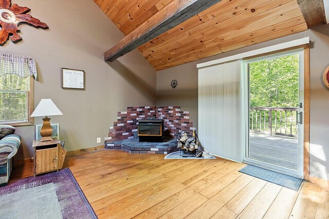 125 Lone Indian Trl, Augusta, ME 04330 - living area with hardwood / wood-style floors, a wood stove, and wood ceiling