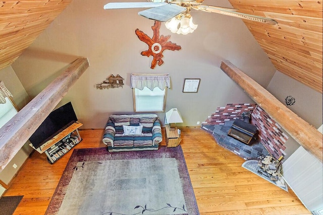 125 Lone Indian Trl, Augusta, ME 04330 - living area featuring lofted ceiling, wood finished floors, ceiling fan, and a wood stove
