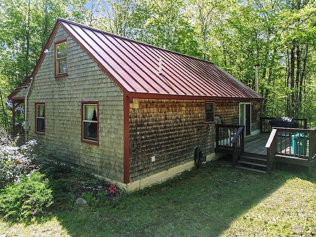 125 Lone Indian Trl, Augusta, ME 04330 - view of property exterior with a standing seam roof, metal roof, a deck, and a lawn