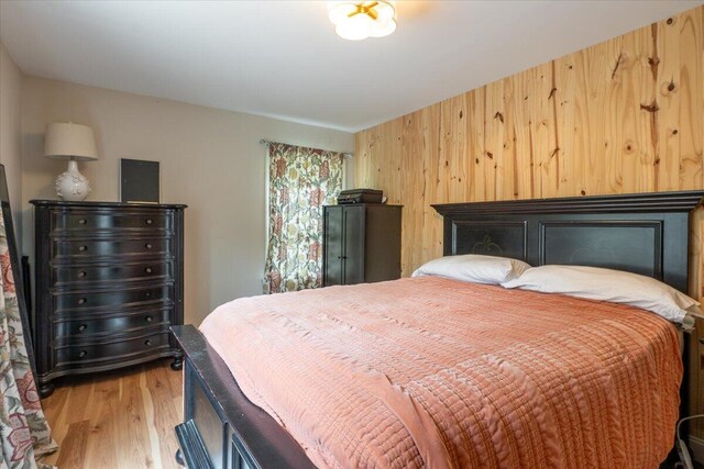144 Woody Ln, Cushing, ME 04563 - bedroom featuring light wood-type flooring and wooden walls