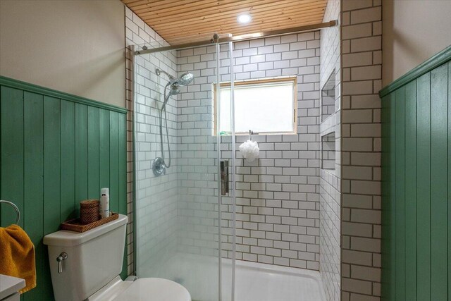 144 Woody Ln, Cushing, ME 04563 - full bath featuring toilet, a stall shower, wainscoting, and wood ceiling