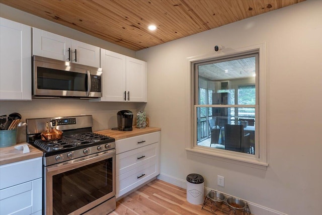 144 Woody Ln, Cushing, ME 04563 - kitchen featuring stainless steel appliances, light wood-style flooring, wood ceiling, white cabinetry, and wood counters