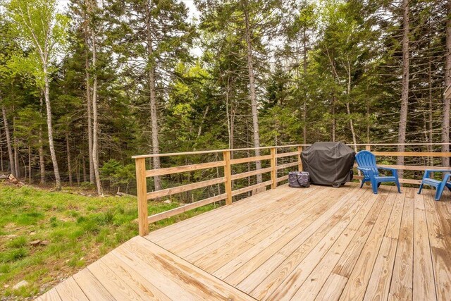 144 Woody Ln, Cushing, ME 04563 - deck with a grill and a view of trees