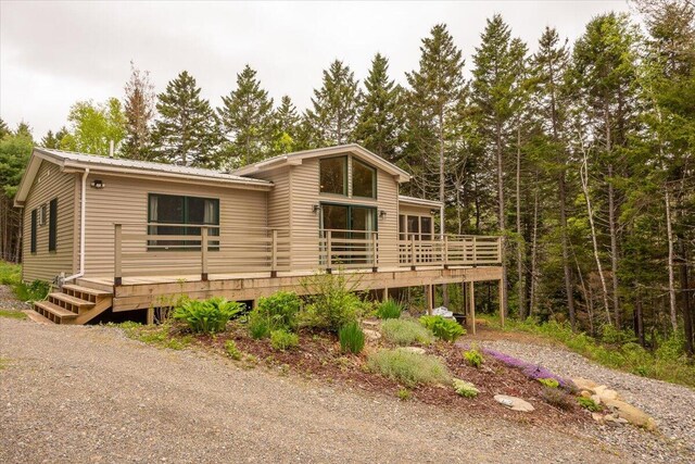 144 Woody Ln, Cushing, ME 04563 - view of front of property with a wooden deck and metal roof