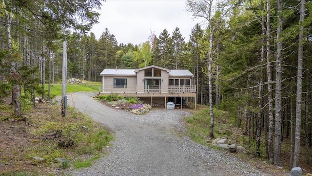 144 Woody Ln, Cushing, ME 04563 - view of front of property featuring a forest view, driveway, and metal roof