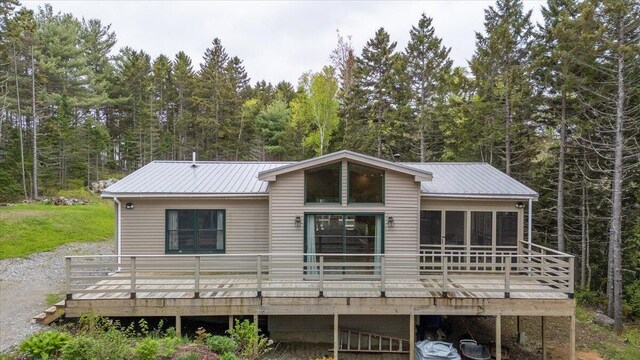 144 Woody Ln, Cushing, ME 04563 - back of property with a wooden deck, a forest view, and metal roof
