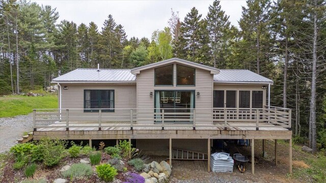144 Woody Ln, Cushing, ME 04563 - rear view of property with a deck, metal roof, and a wooded view